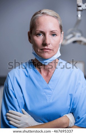 Portrait of dental assistant standing with arm crossed in clinic