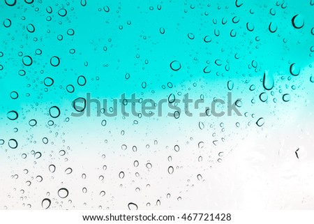 Water drops background. Water drops on glass window over blue sky.