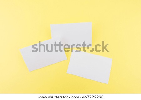 Blank business card with soft shadows on yellow background
