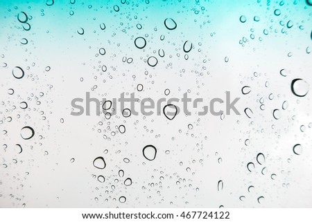 Water drops background. Water drops on glass window over blue sky.