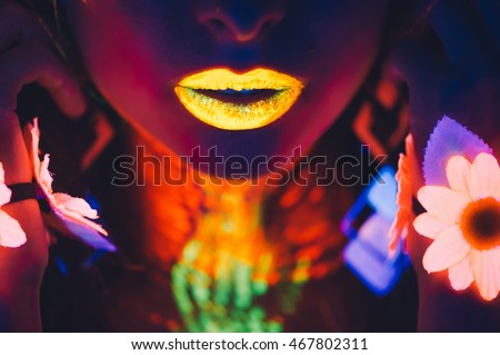 portrait, lips and hands in the neon light, glowing flowers Royalty-Free Stock Photo #467802311