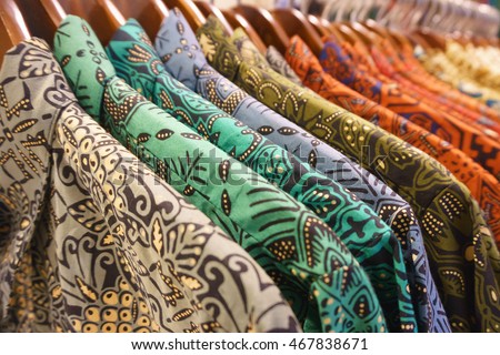 Close-up of popular costume in Indonesia called Batik with beautiful colors hung up for sale. Royalty-Free Stock Photo #467838671