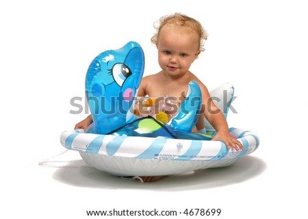 baby on the beach with a swimming toy
