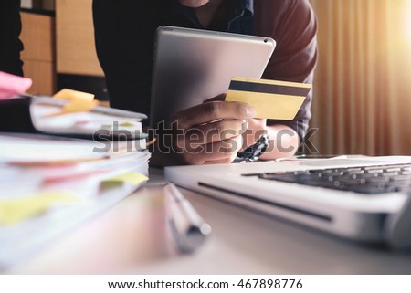 Man hands using tablet laptop and holding credit card with social media as Online shopping concept in morning light