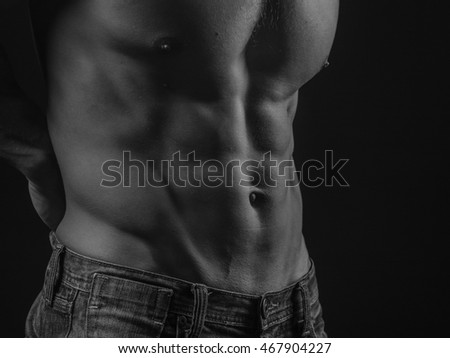 Perfectly shaped torso demonstrating abdominal muscles of a fit young man