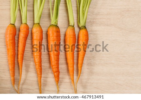 Fresh carrot harvest. Top view. Wood background