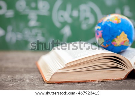 Open book with globe on top 
