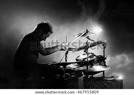 Drummer playing the drums with smoke and powder in the background Royalty-Free Stock Photo #467955809