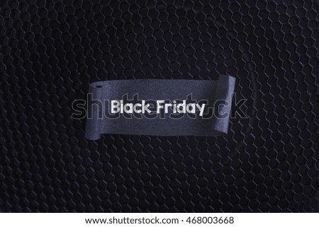 Black papper with Black Friday on black texture background.