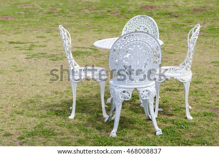 White vintage chairs on grass