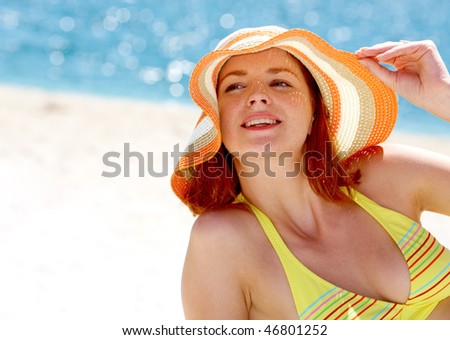 Close-up of pretty lady in hat on the seaside