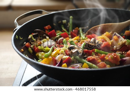 steaming mixed vegetables in the wok, asian style cooking vegetarian and healthy, selected focus, narrow depth of field Royalty-Free Stock Photo #468017558