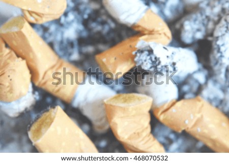 Cigarettes put out with ashes on the background. Intentionally blurred post production for bokeh effect.