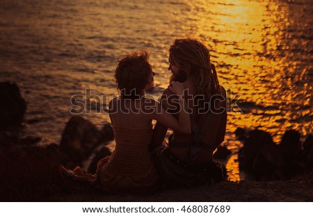 Girl with a guy hugging at sunset