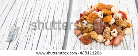 Mix dried super food tiger nuts, mulberry berries, cacao beans, goji berries, golden berry in over wooden background