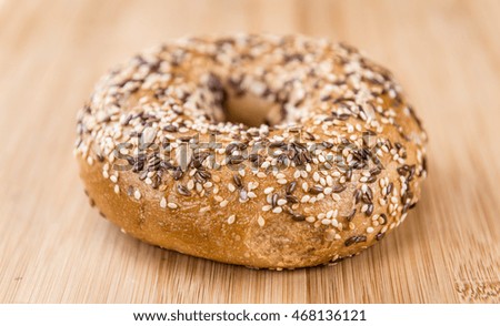Wholemeal Bagels (selective focus; detailed close-up shot) on wooden background