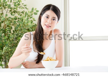 asian woman lose weight by eating cereal for breakfast, healthy lifestyle concept, indoor background