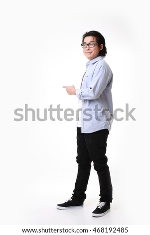 The Asian man standing on the white background.