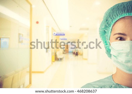 Beautiful doctor woman over hospital background.Vintage color