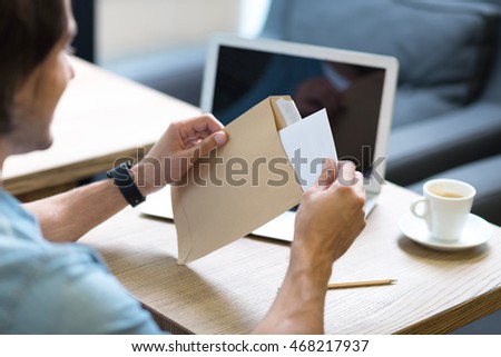 Pleasant man opening a letter Royalty-Free Stock Photo #468217937