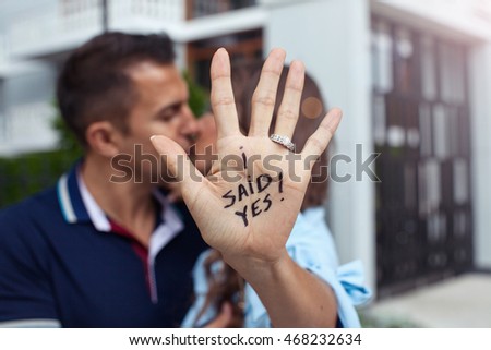 Couple in love kissing. Proposal in the street. Woman said yes. Royalty-Free Stock Photo #468232634