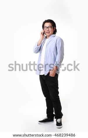 The Asian man standing on the white background.