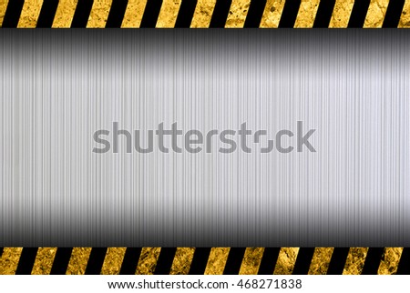 Grunge metal background with black and yellow warning stripes