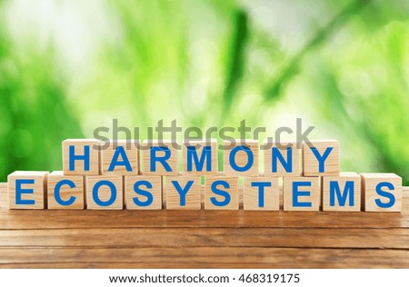 Text harmony ecosystems on wooden blocks. Ecological concept.