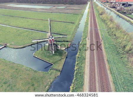 Aerial view of a windmill in the green islands, Holland.