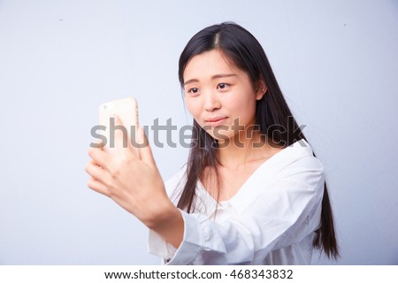 Chinese woman in white photographs herself