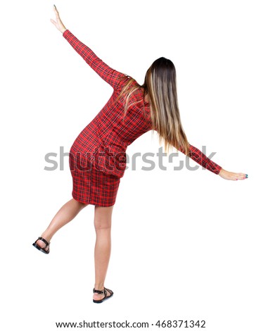 Balancing young woman.  or dodge falling woman. Rear view people collection.  backside view of person.  Isolated over white background. The girl in red plaid dress balancing on his leg.