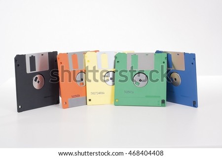 floppy in five colors. Flopy floppy floppys flopys. Old computer data technology. Disc. Flopy disc. Floppy disc. Flopy discs. Floppy discs. Colorful Floppy disc. Flopy disc in orange an green. 