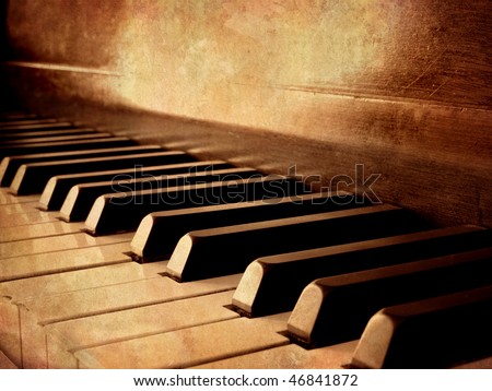 Closeup of black and white piano keys and wood grain with sepia tone