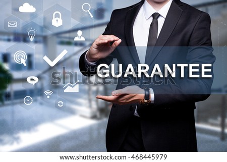 White icon with text "Guarantee" in the hands of a businessman. Business concept. Internet concept.