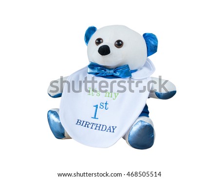 teddy bear with first birthday message on baby bib isolated on white background