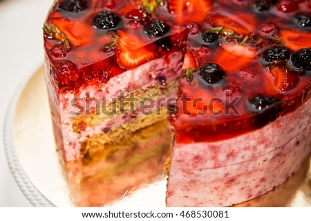 Delicious raspberry cake with fresh strawberries, raspberries, blueberry