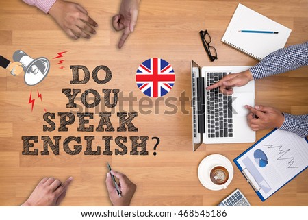 DO YOU SPEAK ENGLISH?                   Businessman working at office desk and using computer and objects on the right, coffee,  top view,