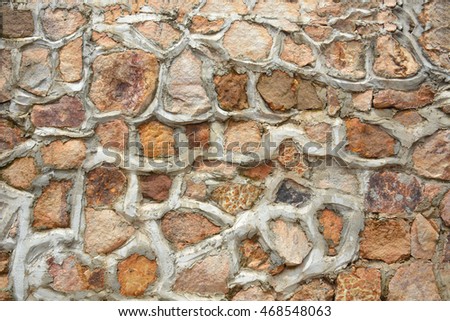 Background wall made of stones held together with cement.