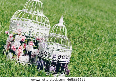 Vintage decorative birdcage with artificial flowers. Beautiful wedding/birthday/romantic decor. Shabby chic birdcages with flowers.