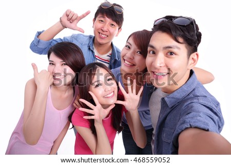 Happy teenagers taking pictures by themselves isolated on white background, asian
