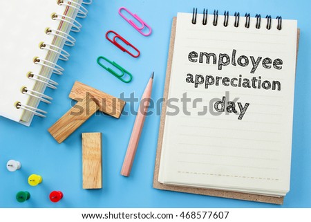 Text Employee appreciation day on white paper book and office supplies on blue desk / business concept Royalty-Free Stock Photo #468577607
