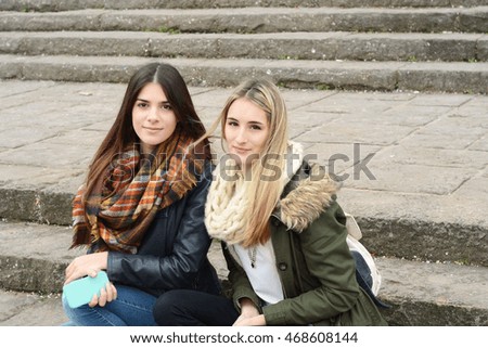 Portrait of two beautiful young girlfriends on a trip together. Tourism concept. Outdoors.