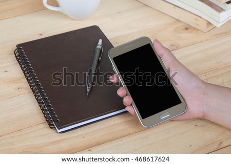 Woman hands with blank cell phone and diary, mock up