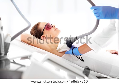 Smooth skin under the arms. Woman on laser hair removal Royalty-Free Stock Photo #468657560