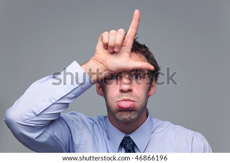 Man in shirt and tie sticking his tongue out and making the letter L with his hand known as the  hand gesture for loser Royalty-Free Stock Photo #46866196