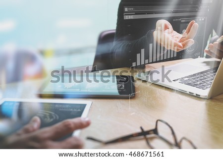 Photo website graphic designer hand meeting team with new project modern studio.laptop digital tablet smart phone on marble table.Books papers documents, sun flare effect
