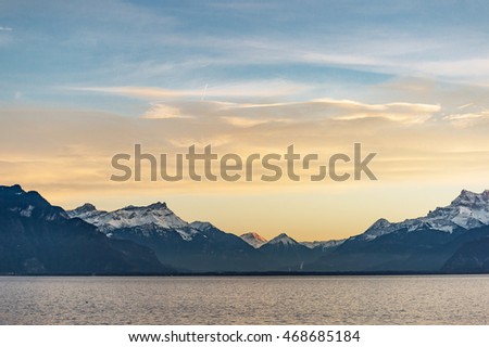 In the evening atmosphere The sun is below the horizon at the lakeside towns of Switzerland .