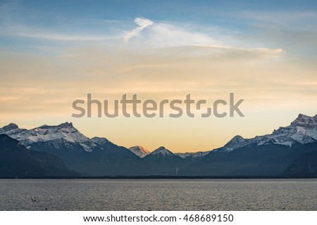 In the evening atmosphere The sun is below the horizon at the lakeside towns of Switzerland .