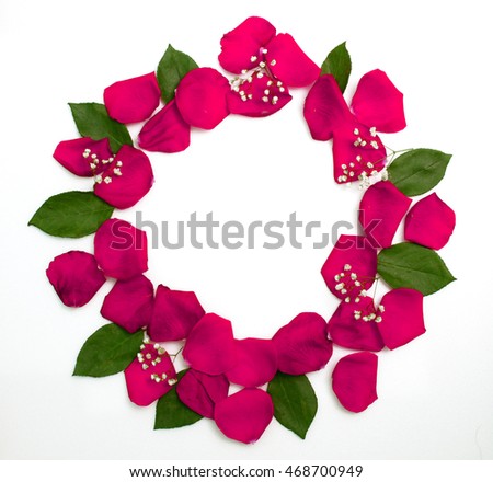 round floral wreath of pink rose petals with green leaves and branches Royalty-Free Stock Photo #468700949