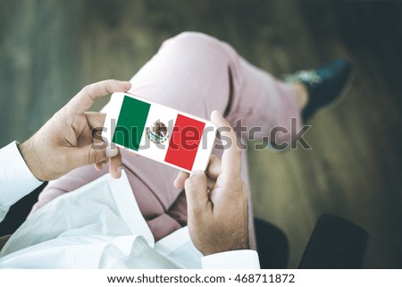 People using smart phone and showing on the screen the flag of MEXICO